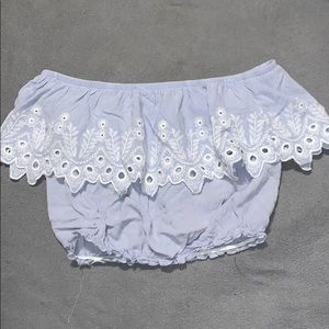 The shoulder cropped baby blue T-shirt